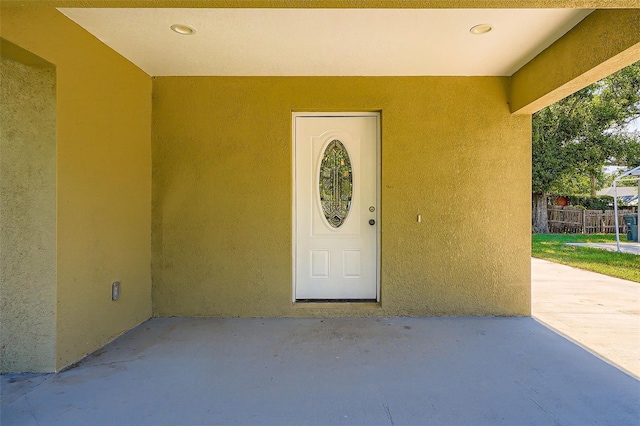 718 17th St E, Bradenton, FL 34208 - doorway to property featuring stucco siding and a patio area