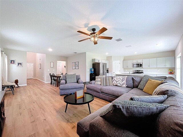 12832 Oak Hill Way, Parrish, FL 34219 - living room with a ceiling fan, light wood-style floors, and recessed lighting