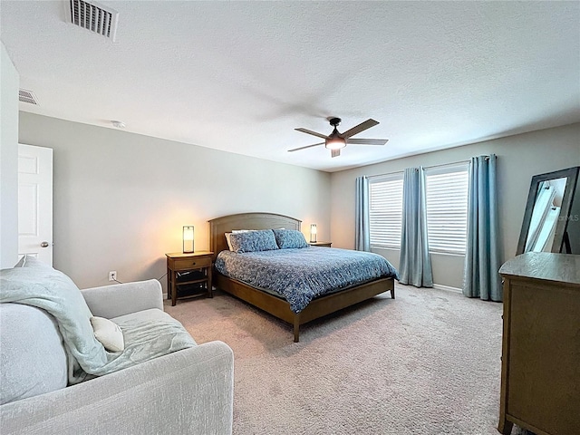 12832 Oak Hill Way, Parrish, FL 34219 - bedroom with light colored carpet, a ceiling fan, and a textured ceiling