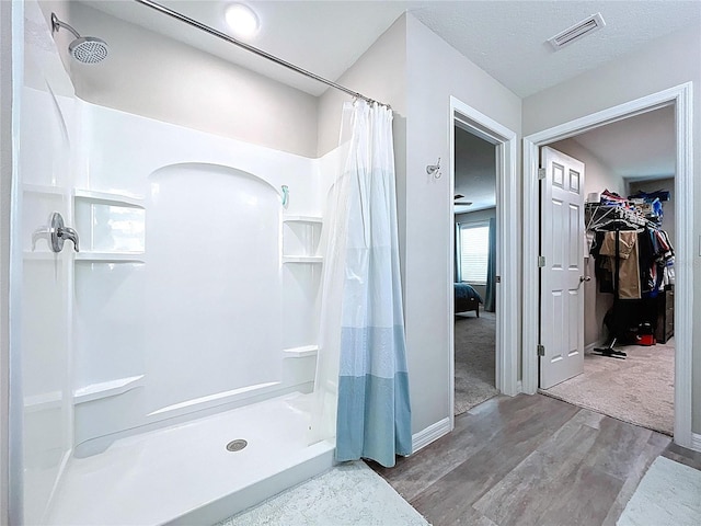 12832 Oak Hill Way, Parrish, FL 34219 - bathroom featuring a shower stall, wood finished floors, and a spacious closet