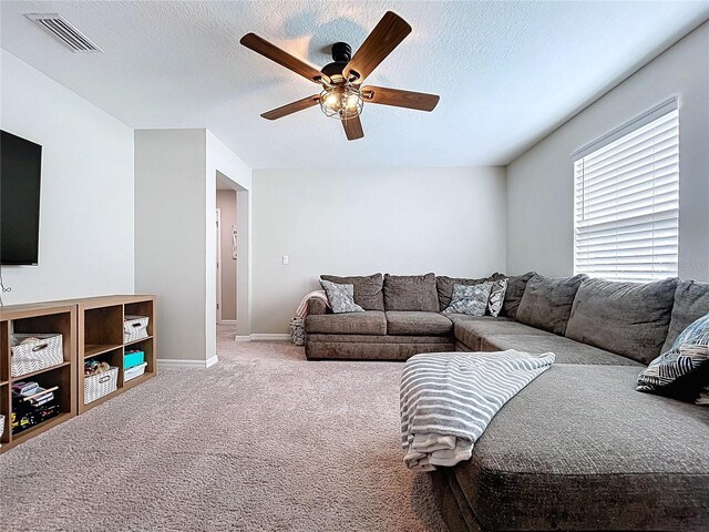12832 Oak Hill Way, Parrish, FL 34219 - living area featuring ceiling fan, carpet floors, and a textured ceiling