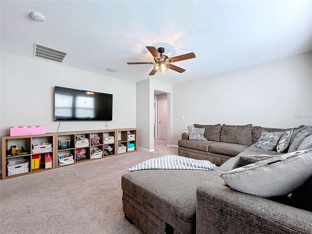 12832 Oak Hill Way, Parrish, FL 34219 - living area with carpet flooring, a ceiling fan, and a textured ceiling