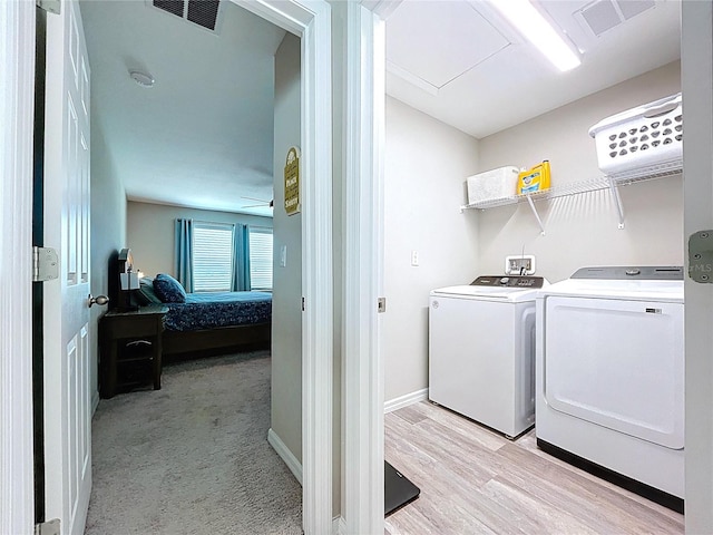 12832 Oak Hill Way, Parrish, FL 34219 - washroom featuring washing machine and clothes dryer and light wood-style floors