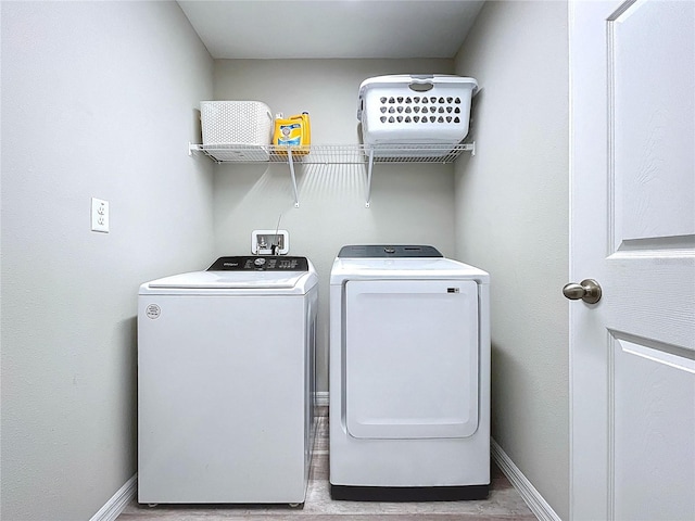 12832 Oak Hill Way, Parrish, FL 34219 - laundry room featuring washing machine and dryer and wood finished floors
