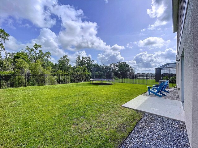12832 Oak Hill Way, Parrish, FL 34219 - fenced backyard with a trampoline and a patio