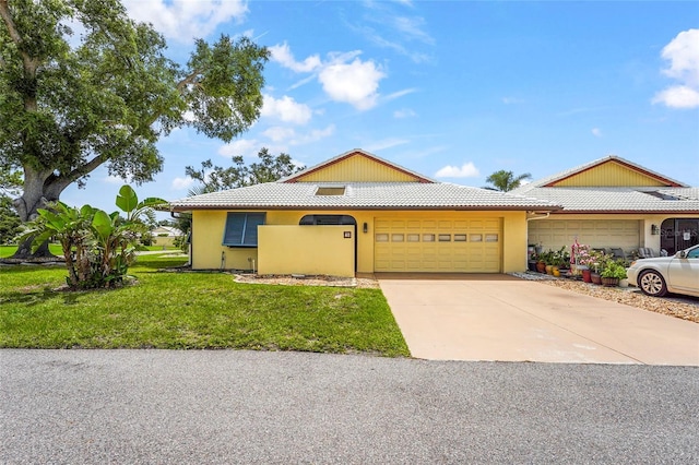 20 Idle Sands Dr, Venice, FL 34293 - view of front facade featuring a garage, a tiled roof, a front yard, stucco siding, and concrete driveway