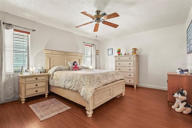 20 Idle Sands Dr, Venice, FL 34293 - bedroom featuring dark wood-style flooring, a textured ceiling, and a ceiling fan
