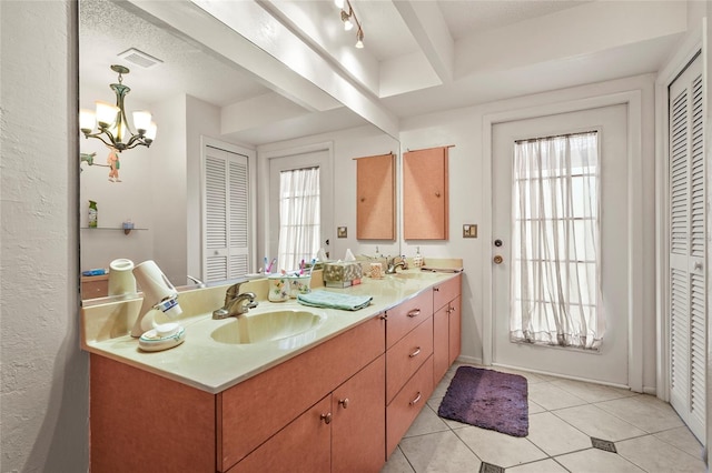 20 Idle Sands Dr, Venice, FL 34293 - full bath with a closet, double vanity, tile patterned flooring, and a chandelier