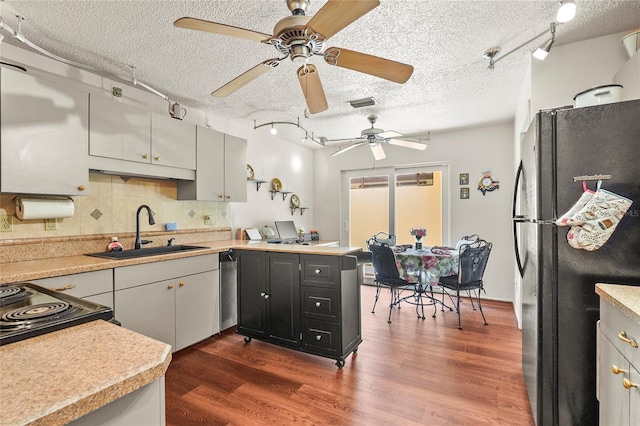 20 Idle Sands Dr, Venice, FL 34293 - kitchen featuring freestanding refrigerator, a textured ceiling, light countertops, ceiling fan, and tasteful backsplash