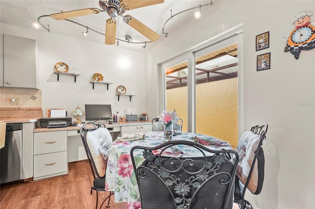 20 Idle Sands Dr, Venice, FL 34293 - dining room with track lighting, light wood-style floors, ceiling fan, and a textured ceiling