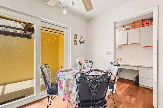 20 Idle Sands Dr, Venice, FL 34293 - dining area featuring a ceiling fan, wood finished floors, and built in desk
