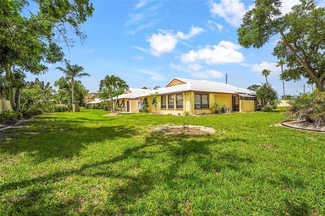 20 Idle Sands Dr, Venice, FL 34293 - back of house featuring a yard