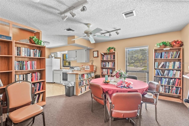 20 Idle Sands Dr, Venice, FL 34293 - dining space featuring ceiling fan, track lighting, carpet, and a textured ceiling