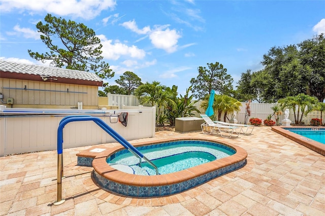 20 Idle Sands Dr, Venice, FL 34293 - view of swimming pool featuring a community hot tub, a patio area, and a fenced backyard