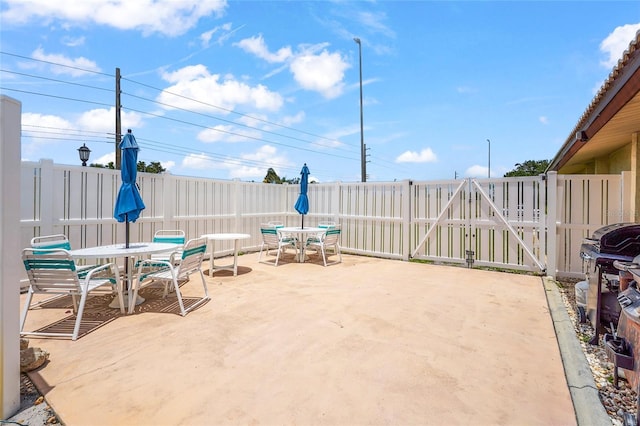 20 Idle Sands Dr, Venice, FL 34293 - view of patio with outdoor dining space, a gate, and area for grilling