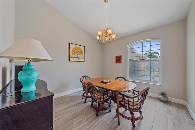 5523 Secluded Oaks Way, Sarasota, FL 34233 - dining space featuring light wood finished floors, a chandelier, and vaulted ceiling