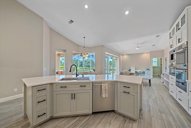 5523 Secluded Oaks Way, Sarasota, FL 34233 - kitchen featuring appliances with stainless steel finishes, a ceiling fan, open floor plan, light countertops, and lofted ceiling