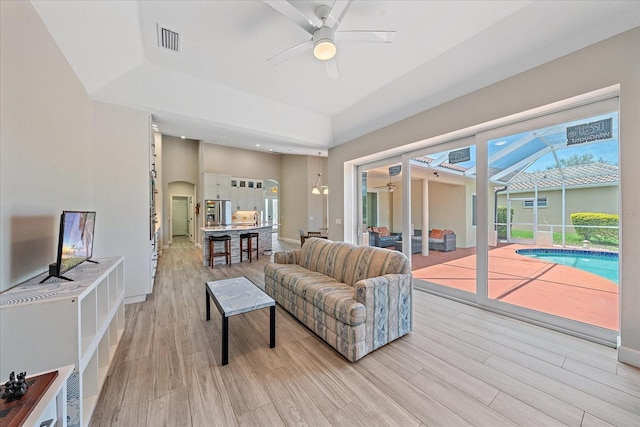 5523 Secluded Oaks Way, Sarasota, FL 34233 - living room featuring ceiling fan and light wood-style flooring