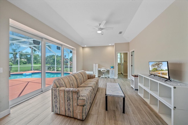 5523 Secluded Oaks Way, Sarasota, FL 34233 - living area with a ceiling fan, a sunroom, wood finished floors, and recessed lighting