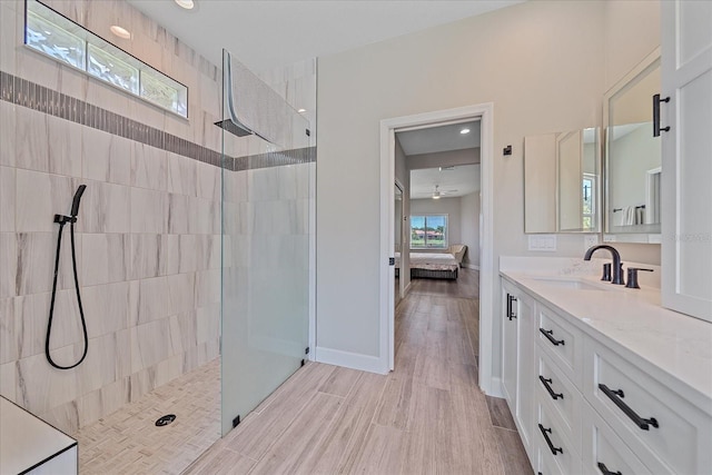 5523 Secluded Oaks Way, Sarasota, FL 34233 - full bath with ensuite bath, a walk in shower, vanity, and wood finished floors
