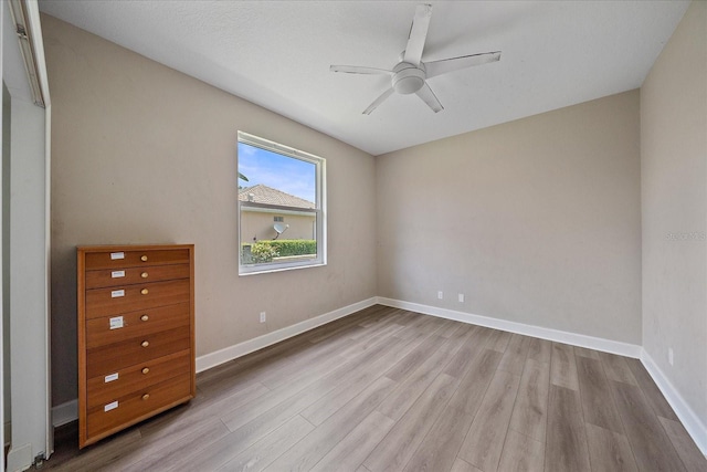 5523 Secluded Oaks Way, Sarasota, FL 34233 - unfurnished bedroom featuring wood finished floors and a ceiling fan