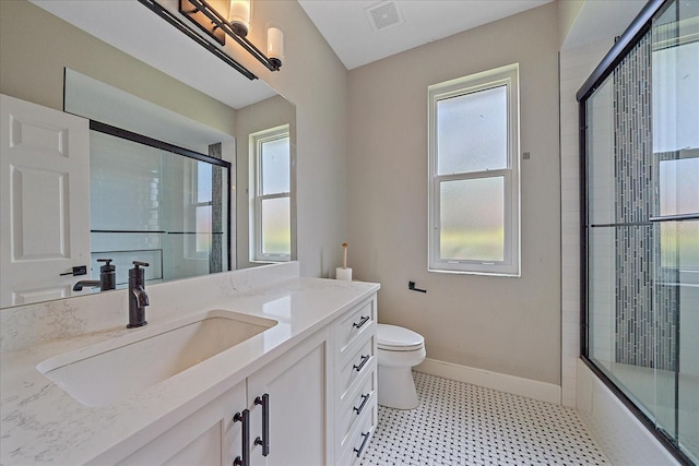 5523 Secluded Oaks Way, Sarasota, FL 34233 - bathroom featuring vanity, healthy amount of natural light, tile patterned floors, and enclosed tub / shower combo