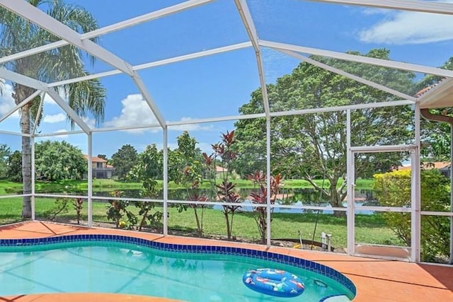 5523 Secluded Oaks Way, Sarasota, FL 34233 - outdoor pool with glass enclosure, view of scattered trees, and a water view