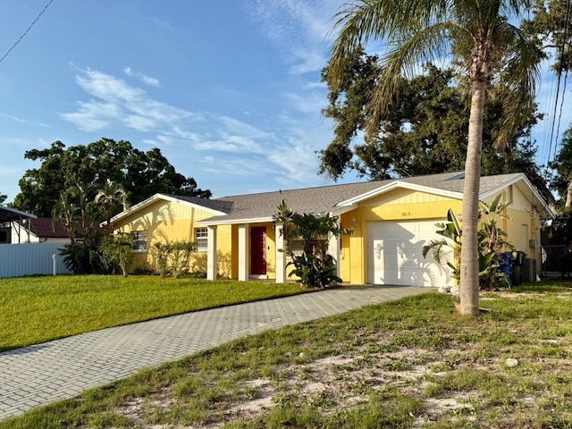 5615 Waneta Pl, Sarasota, FL 34231 - view of front of house featuring an attached garage and decorative driveway