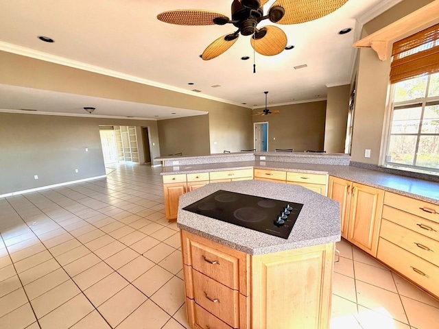 5615 Waneta Pl, Sarasota, FL 34231 - kitchen with black electric stovetop, light brown cabinetry, ceiling fan, light tile patterned floors, and crown molding