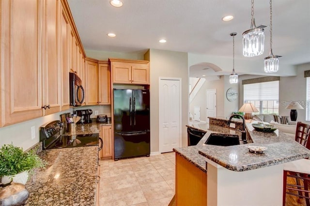 8168 Villa Grande Ct, Sarasota, FL 34243 - kitchen featuring black appliances, recessed lighting, stone countertops, pendant lighting, and a large island