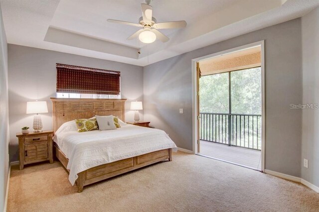 8168 Villa Grande Ct, Sarasota, FL 34243 - bedroom featuring access to exterior, a raised ceiling, light colored carpet, and a ceiling fan
