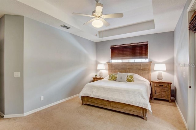 8168 Villa Grande Ct, Sarasota, FL 34243 - carpeted bedroom with a tray ceiling and ceiling fan