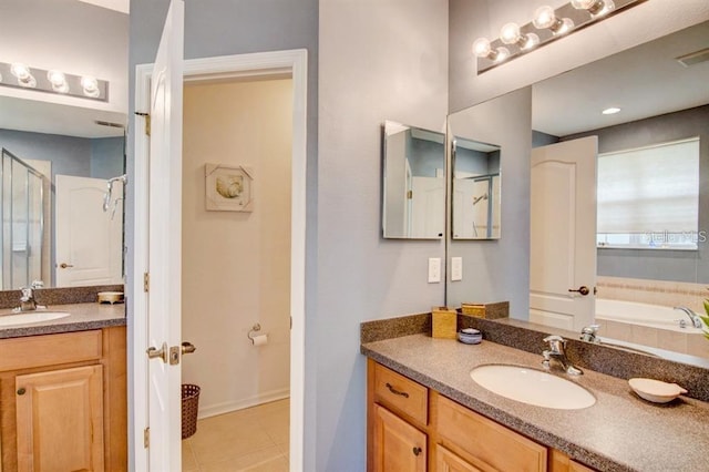 8168 Villa Grande Ct, Sarasota, FL 34243 - full bathroom featuring vanity, tile patterned flooring, a garden tub, and a stall shower