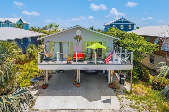 2513 Avenue B Ave B, Unit B, Bradenton Beach, FL 34217 - back of house featuring a carport, a deck, and driveway