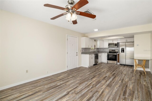 2513 Avenue B Ave B, Unit B, Bradenton Beach, FL 34217 - kitchen featuring appliances with stainless steel finishes, dark wood-style floors, tasteful backsplash, white cabinetry, and a ceiling fan