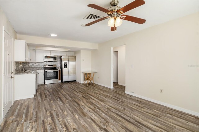 2513 Avenue B Ave B, Unit B, Bradenton Beach, FL 34217 - kitchen featuring appliances with stainless steel finishes, dark wood-type flooring, and white cabinetry