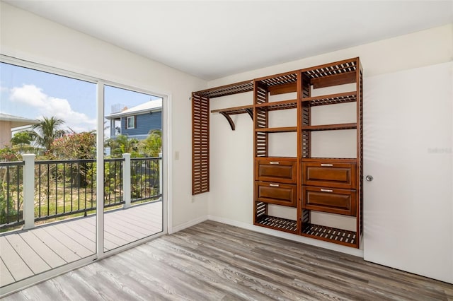 2513 Avenue B Ave B, Unit B, Bradenton Beach, FL 34217 - unfurnished bedroom featuring access to outside and wood finished floors