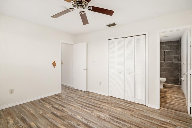 2513 Avenue B Ave B, Unit B, Bradenton Beach, FL 34217 - unfurnished bedroom featuring wood finished floors, a closet, connected bathroom, and ceiling fan