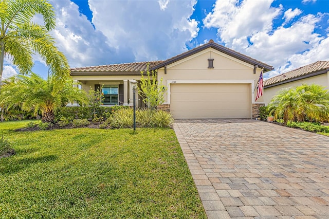 6507 Clairborne Ln, Bradenton, FL 34211 - view of front of property with decorative driveway, stucco siding, a front yard, a garage, and a tile roof