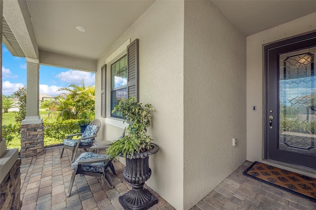 6507 Clairborne Ln, Bradenton, FL 34211 - view of exterior entry featuring stucco siding and covered porch