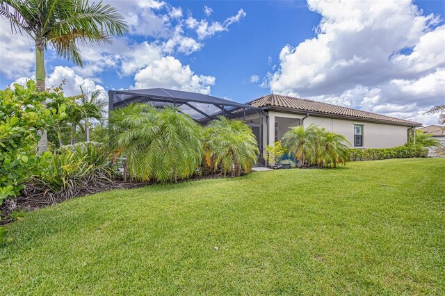 6507 Clairborne Ln, Bradenton, FL 34211 - view of grassy yard with glass enclosure