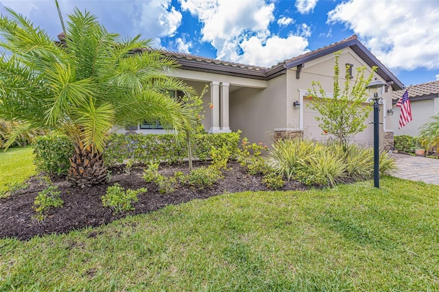 6507 Clairborne Ln, Bradenton, FL 34211 - view of front facade with an attached garage, a tiled roof, stucco siding, and a front yard