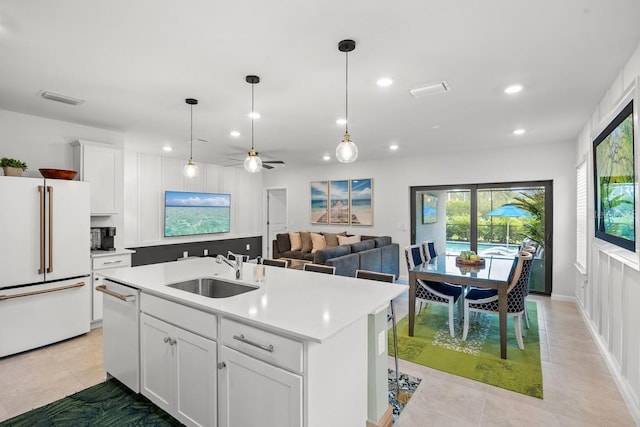 6563 Silverstar Dr, Sarasota, FL 34240 - kitchen featuring high end fridge, recessed lighting, dishwasher, light countertops, and white cabinetry