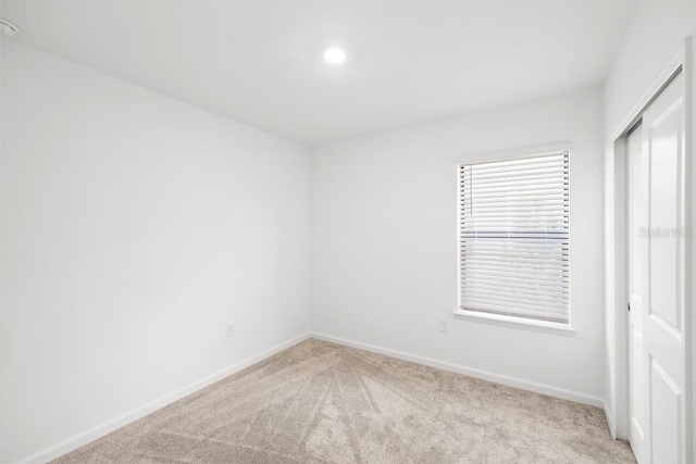 6563 Silverstar Dr, Sarasota, FL 34240 - unfurnished bedroom featuring light colored carpet and a closet