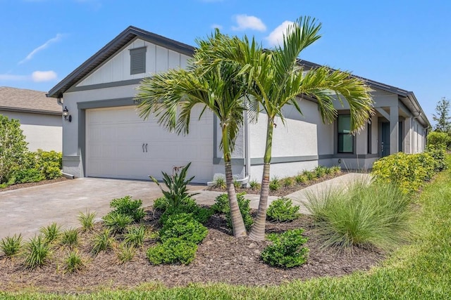 6563 Silverstar Dr, Sarasota, FL 34240 - view of front of property with a garage, driveway, and stucco siding