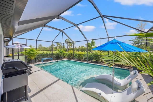 6563 Silverstar Dr, Sarasota, FL 34240 - swimming pool featuring a patio area, a grill, and glass enclosure