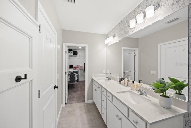 6563 Silverstar Dr, Sarasota, FL 34240 - bathroom with double vanity and a walk in closet