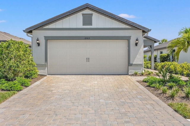 6563 Silverstar Dr, Sarasota, FL 34240 - single story home with decorative driveway, board and batten siding, and an attached garage