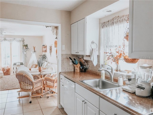 6004/6014 Deming Ave, North Port, FL 34287 - kitchen featuring dishwasher, a sink, white cabinetry, decorative backsplash, and light tile patterned floors