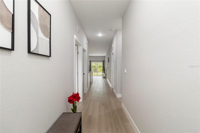 9417 Agate St, Port Charlotte, FL 33981 - hall with light wood finished floors, baseboards, and recessed lighting